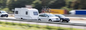 Caravaners - top tips for towing - a car towing a caravan on the motorway.