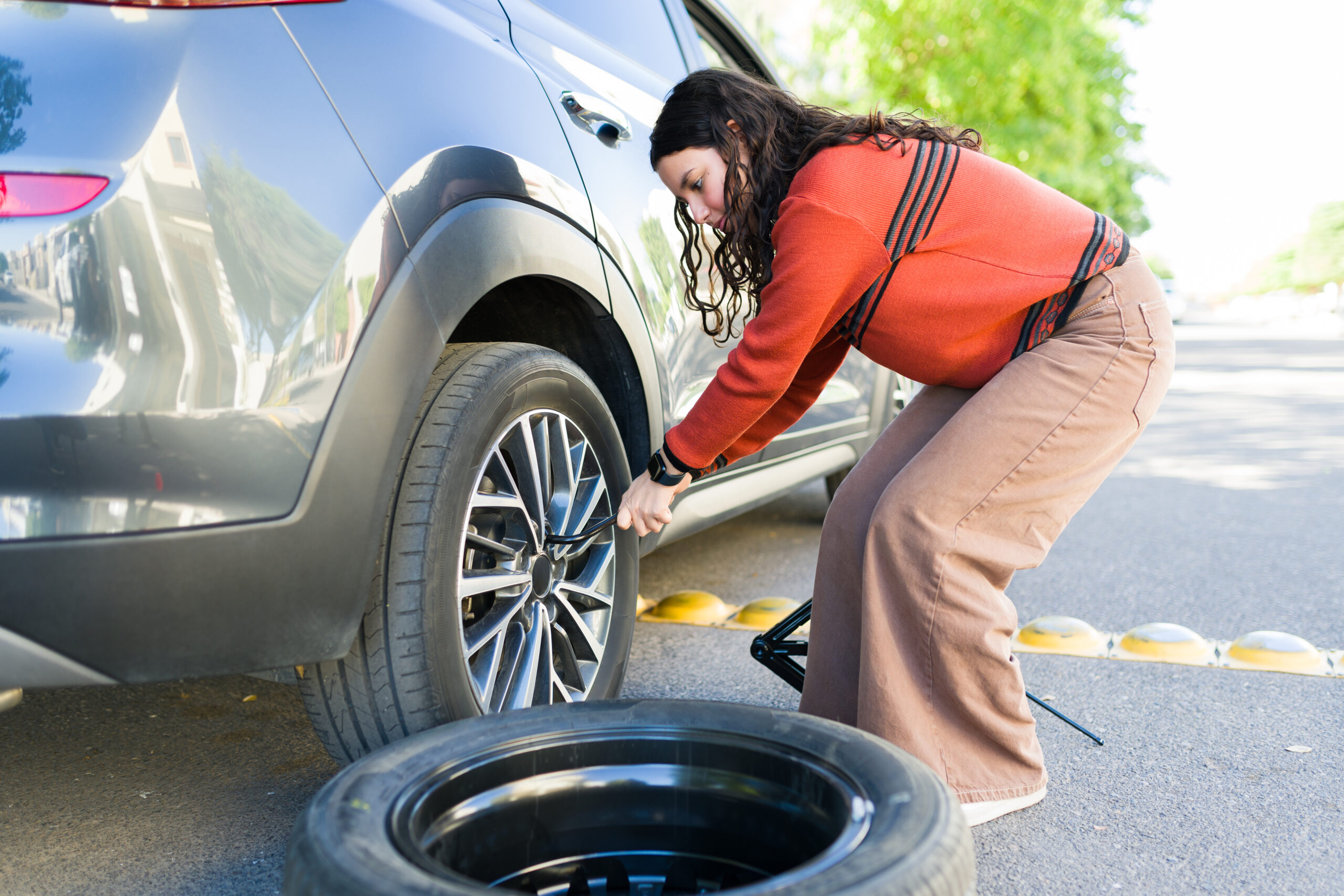 Woman looking after her car tyres