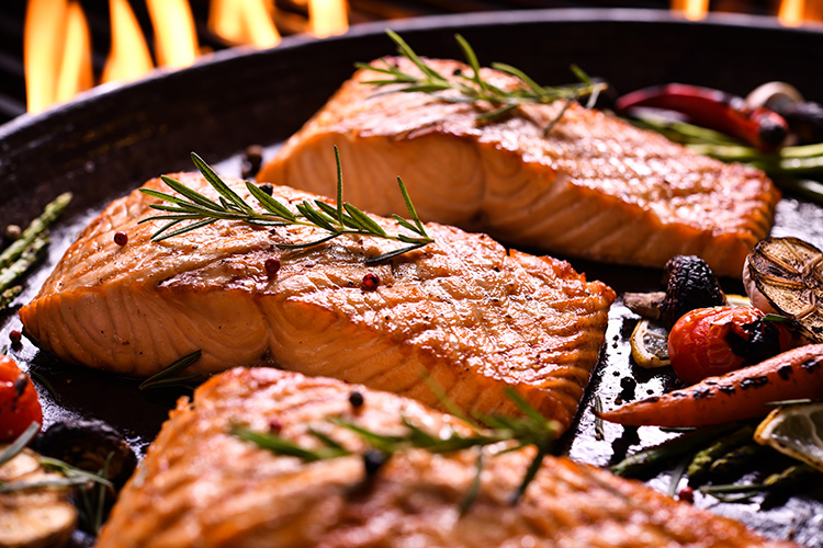 3 Healthy Fish Recipes For Spring - Salmon cooking in a pan