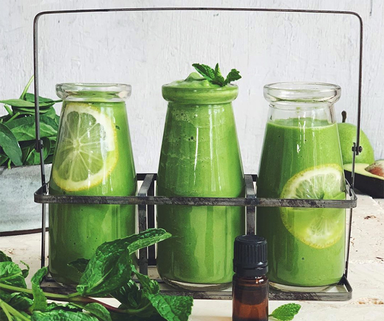 Three bottles of green juice in a carrier