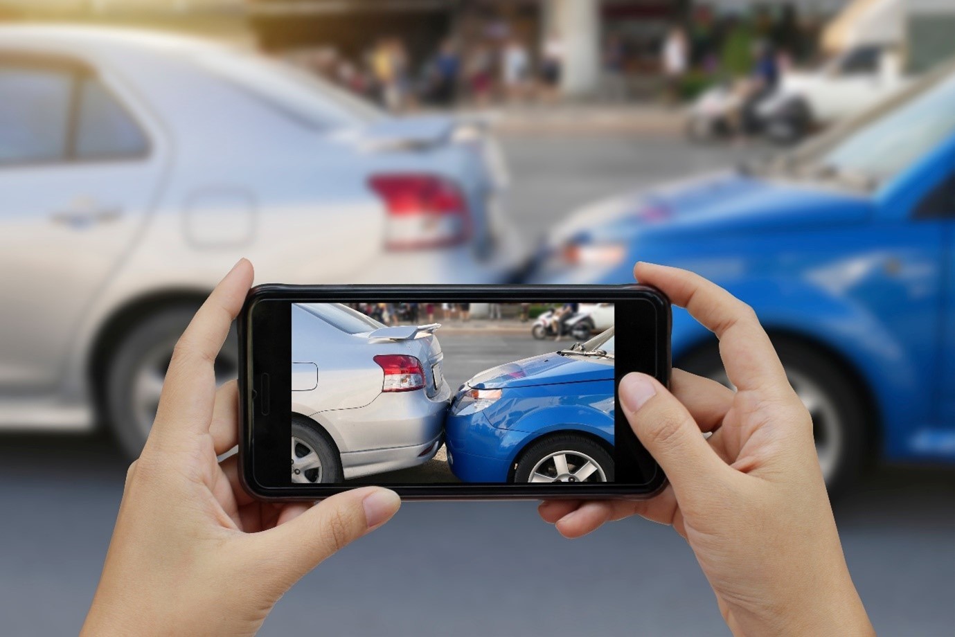 Someone taking a photo of car accident