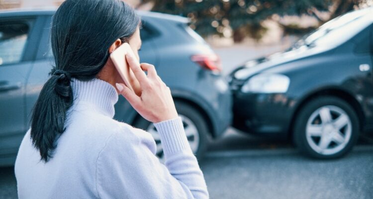 Woman on the phone after having a crash