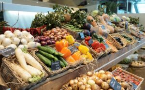 Vegetables on display at a market in wicker baskets