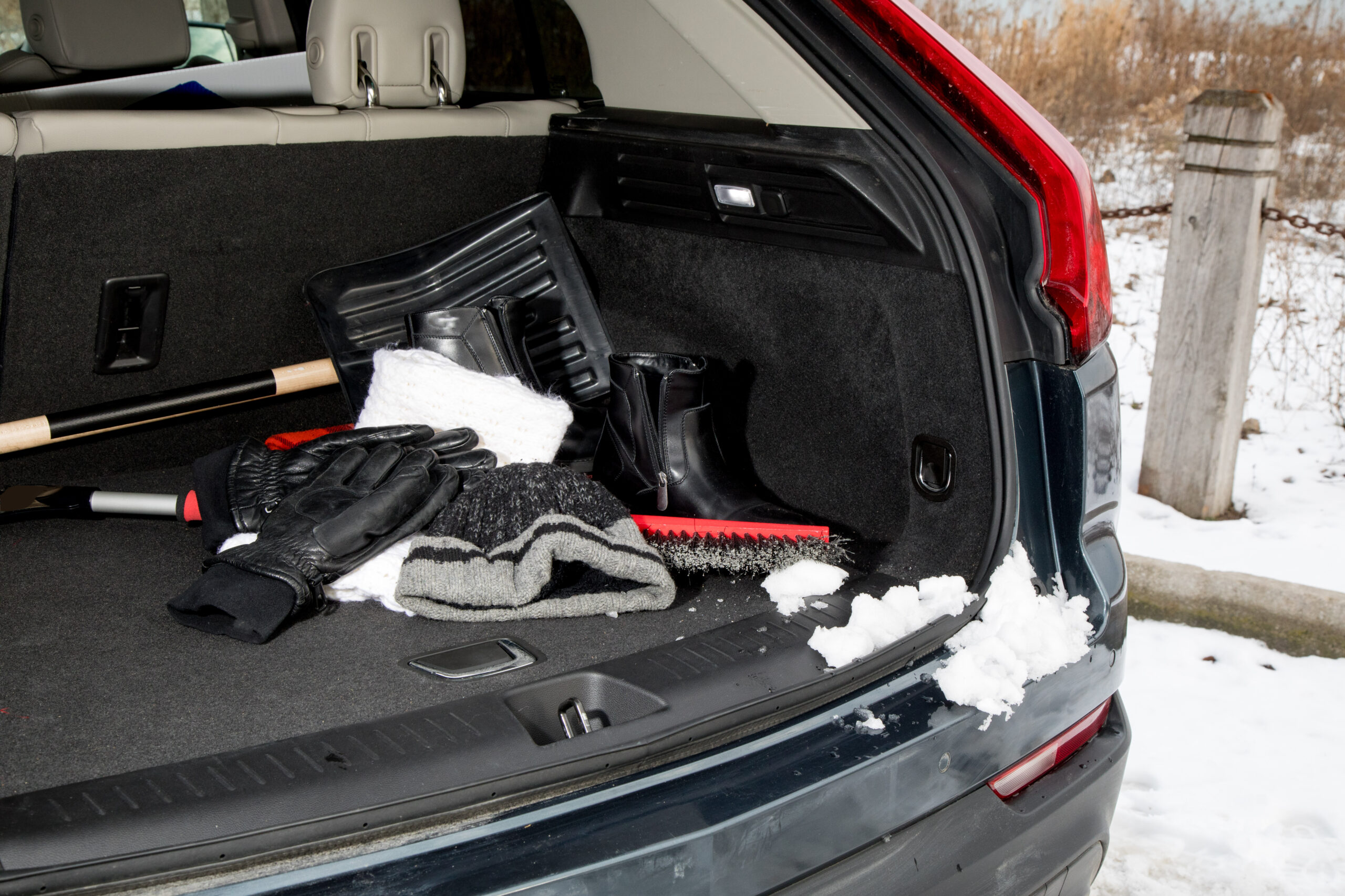 snow shovel in boot of car