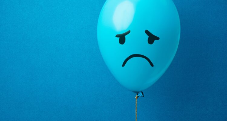 Blue Balloon with Sad Smile Drawn On