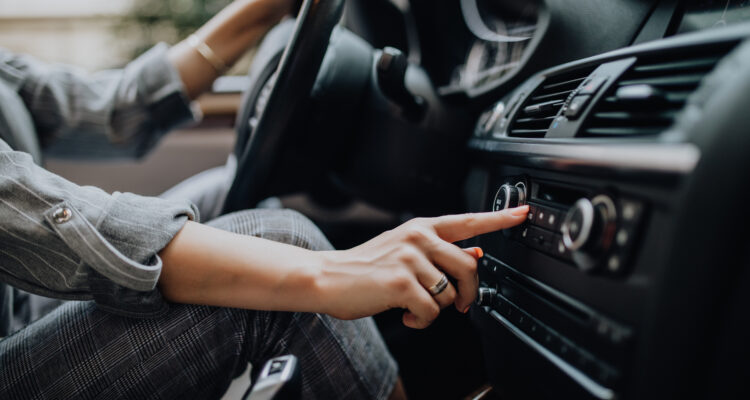 Woman turning on her air conditioning