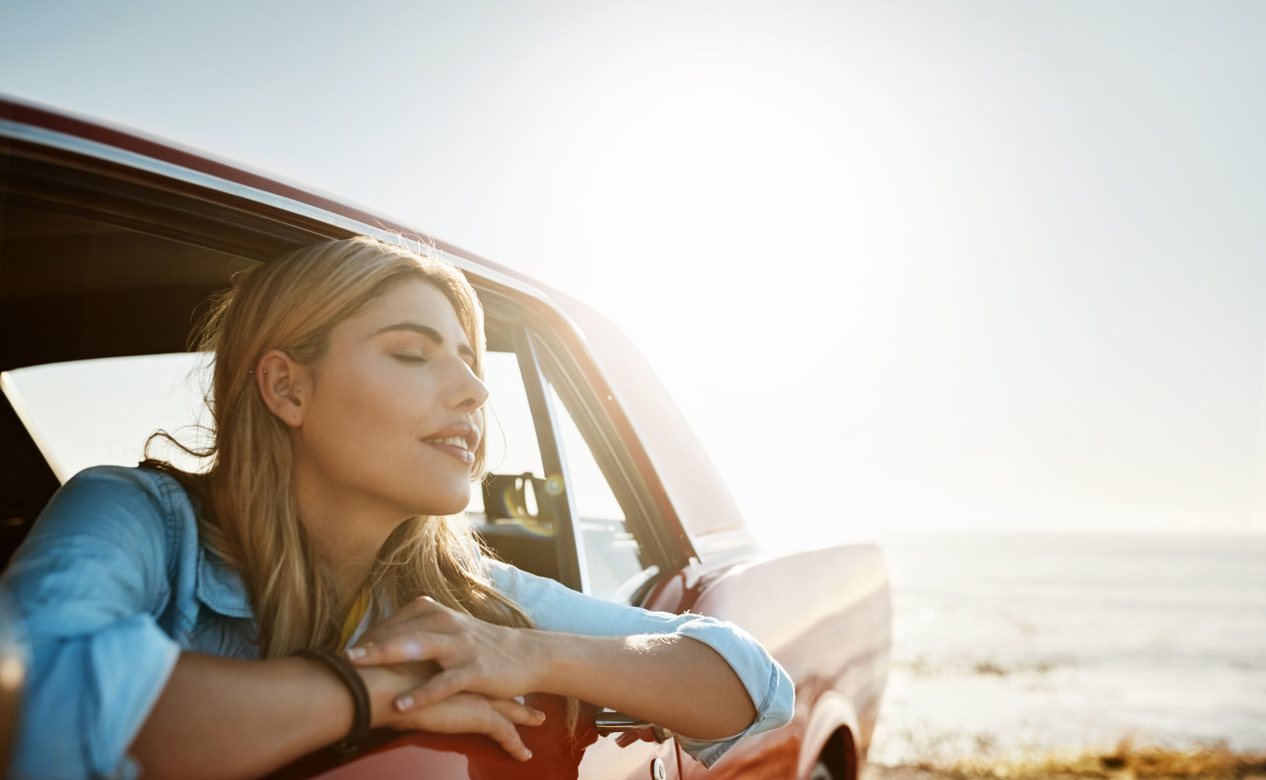 Lady feeling zen in her car 