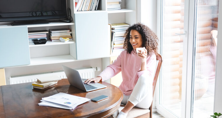 Woman sat her dining table working from home