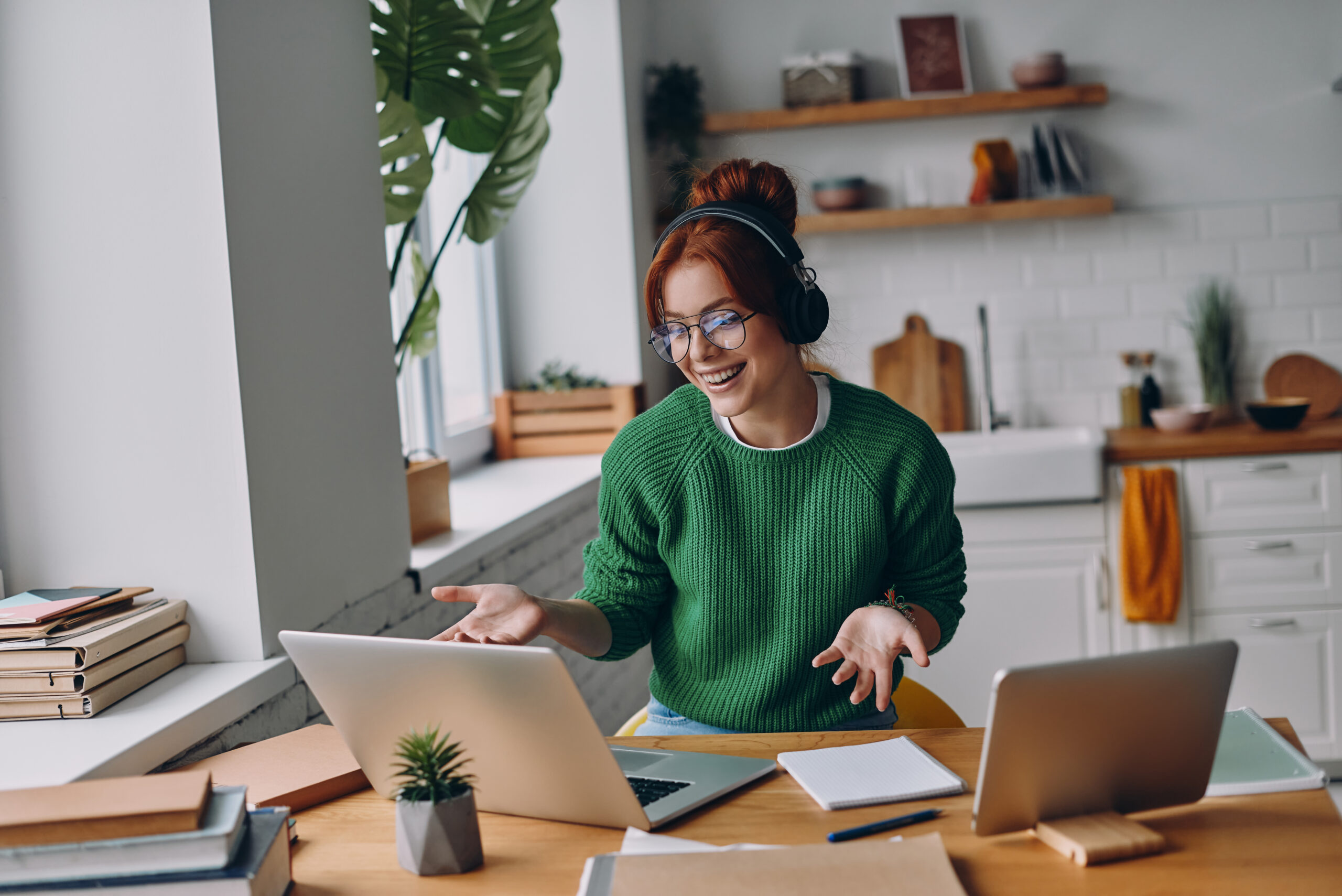 Women working from home with headphones on 