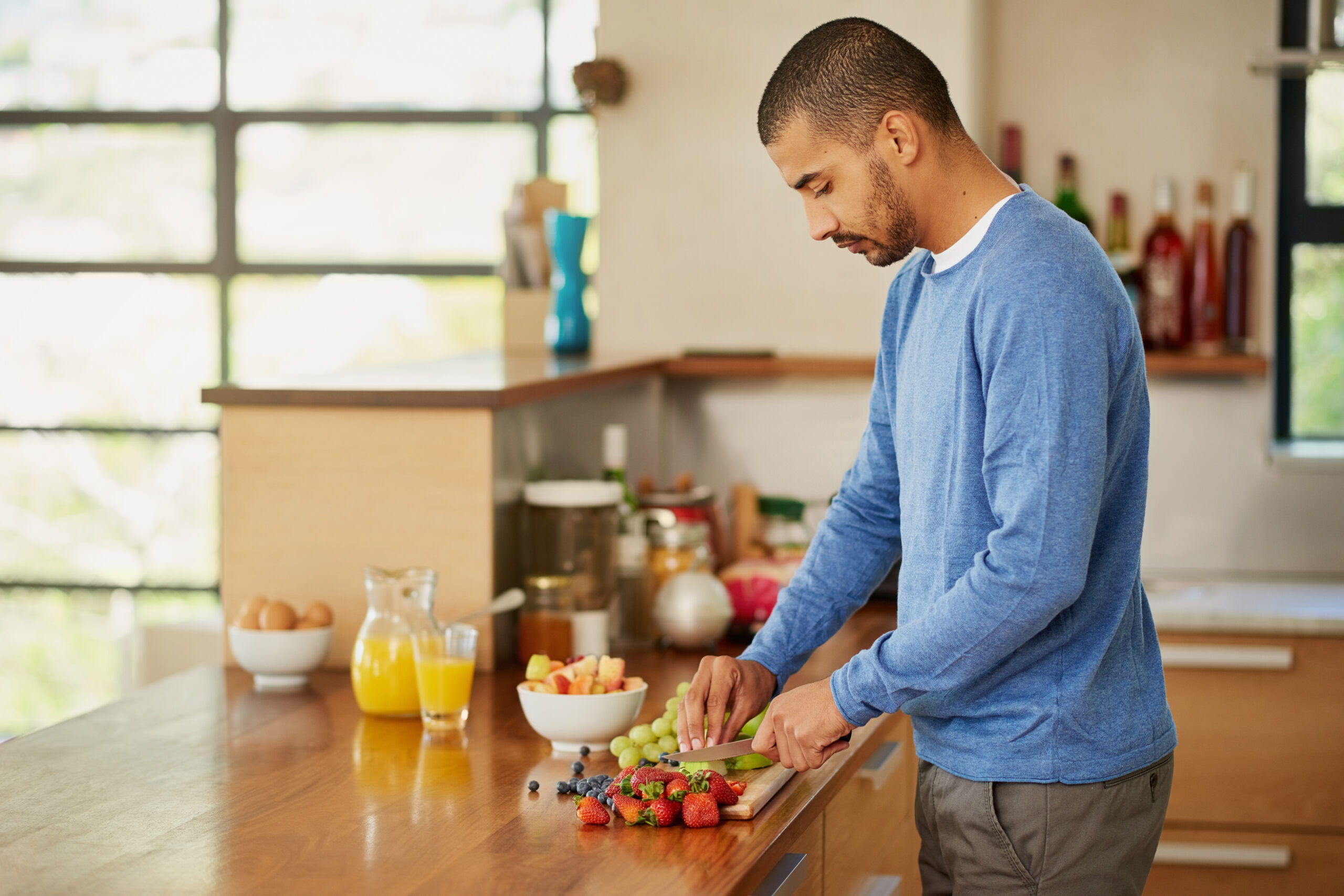 Man preparing fresh fruit juice 