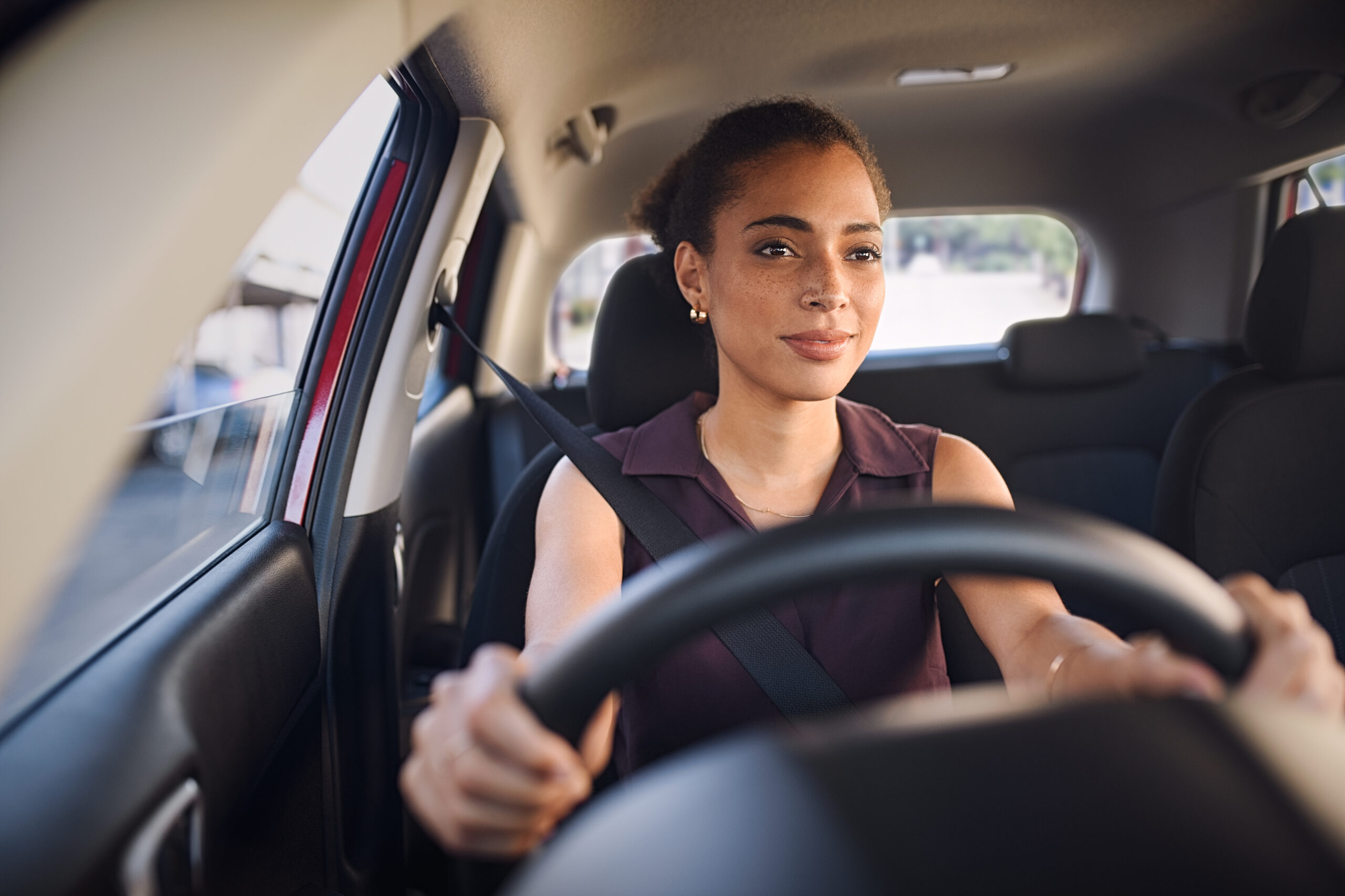 Lady driving car with good posture 