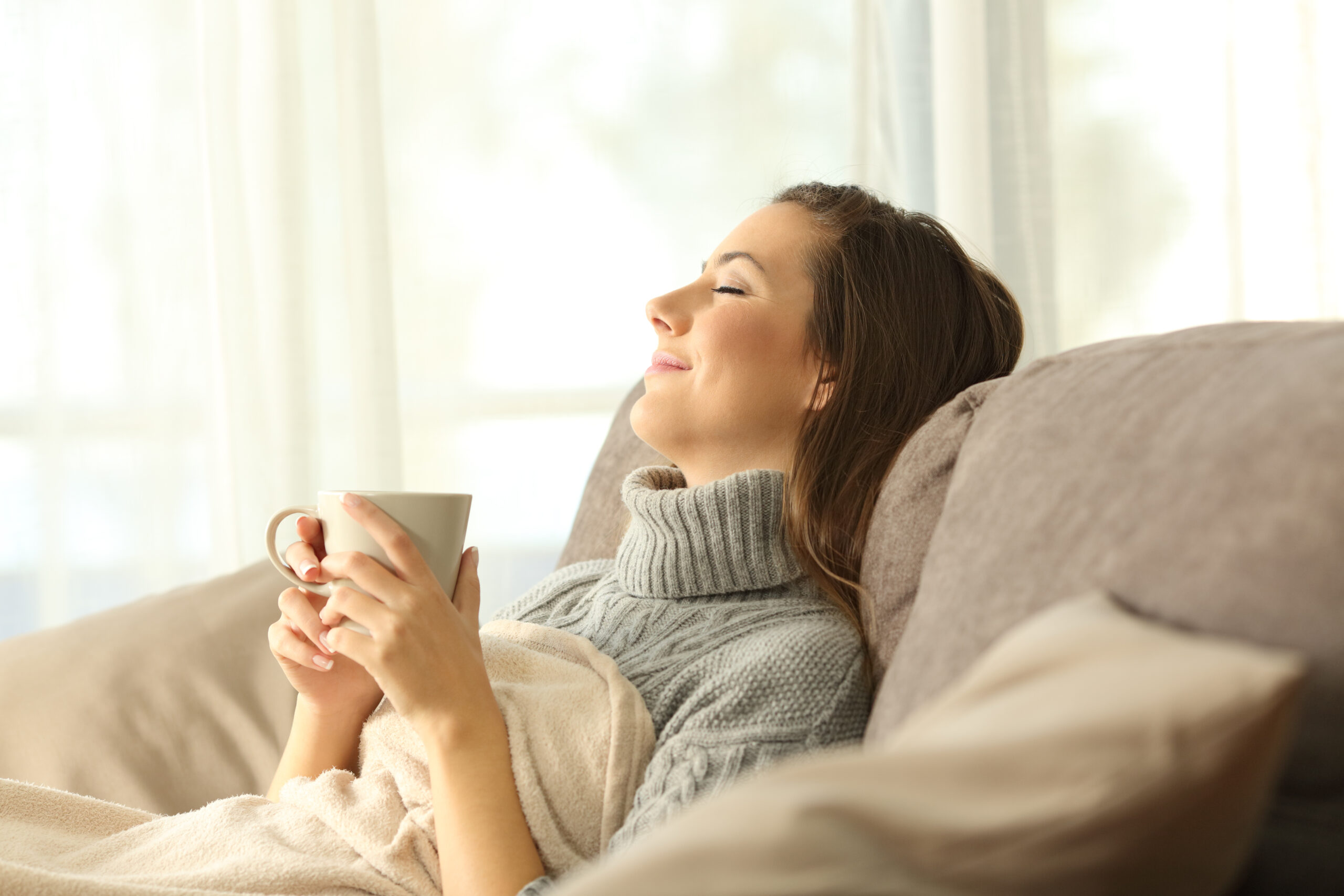 Woman using blanket in home