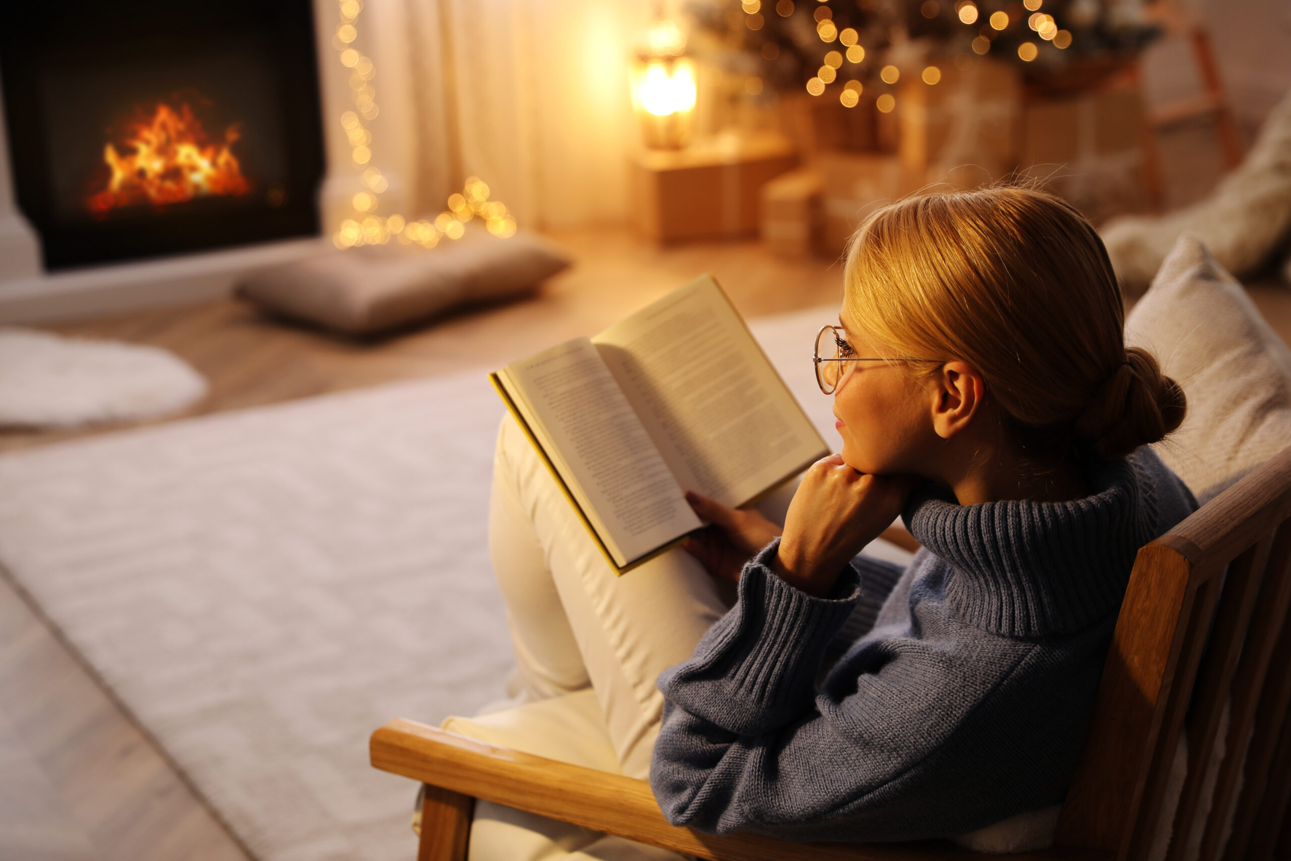 Woman reading a book at Christmas 