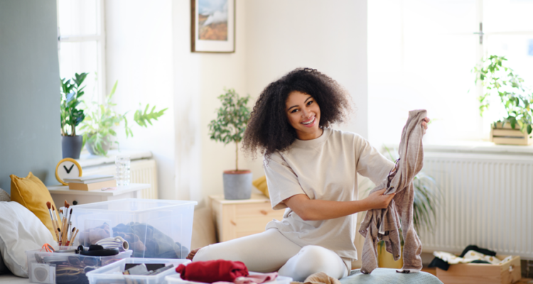 Woman sorting through clothes for charity